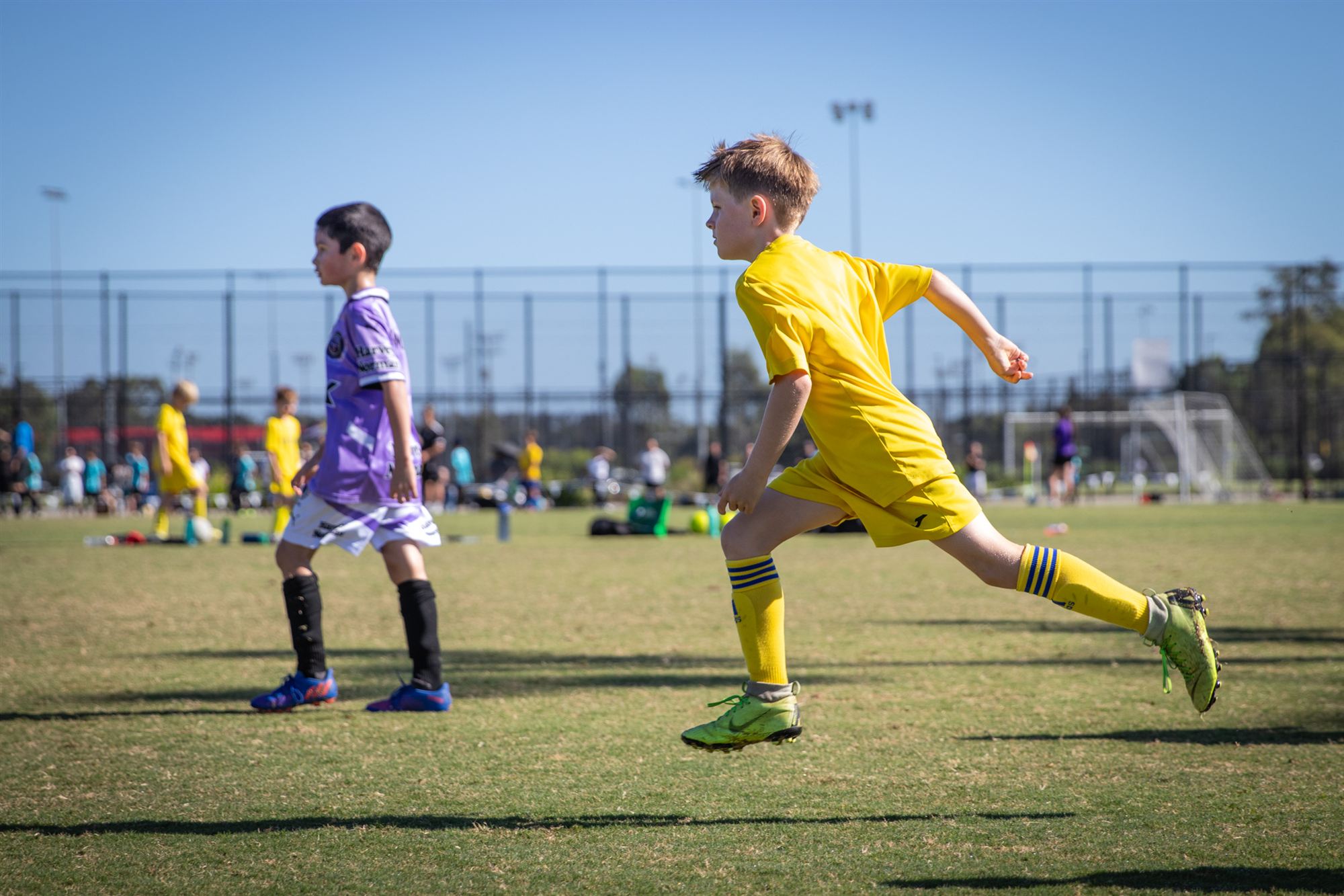 Player at full sprint against a clear blue sky