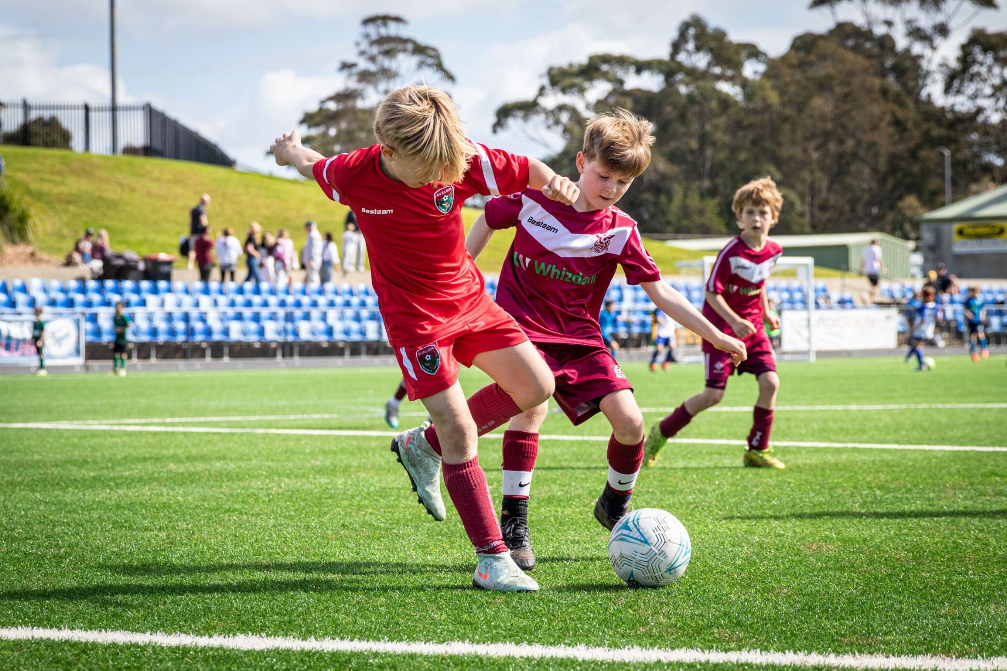 Two players challenging shoulder to shoulder for the ball