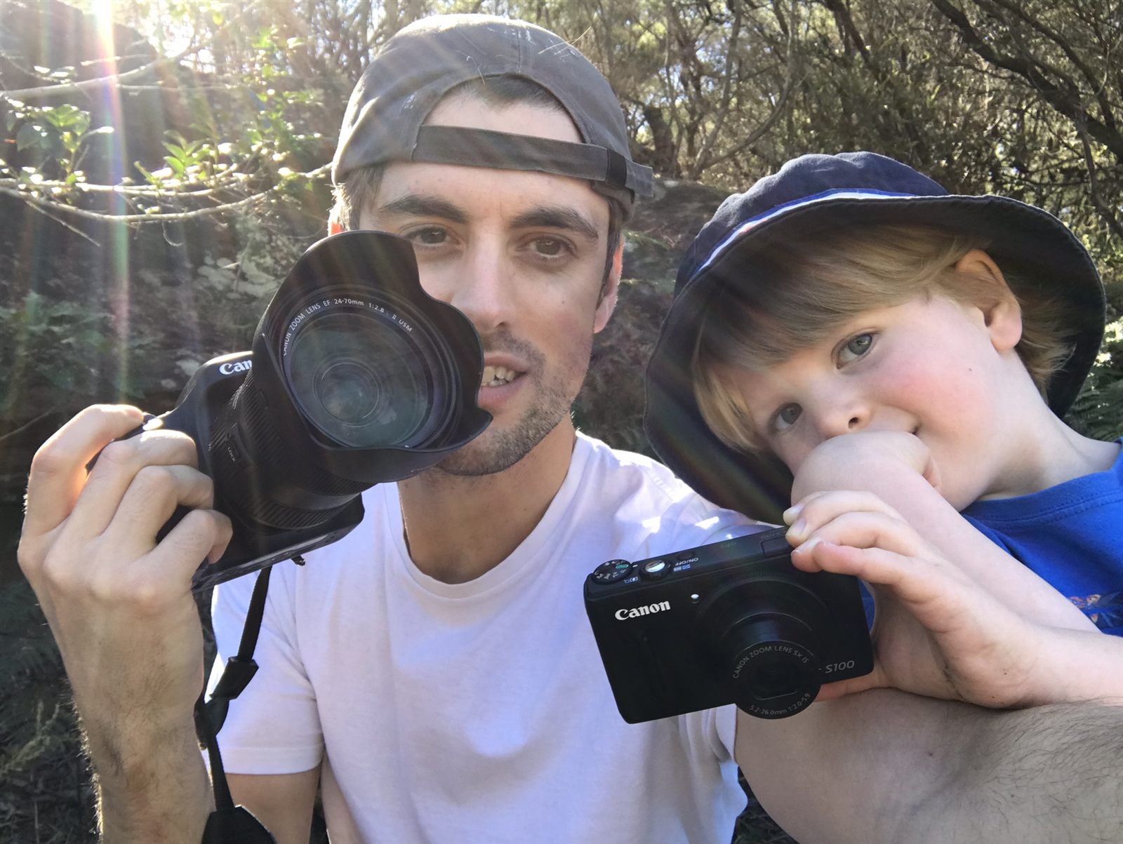 The photographer with his son, cameras in hand, out on a walk
