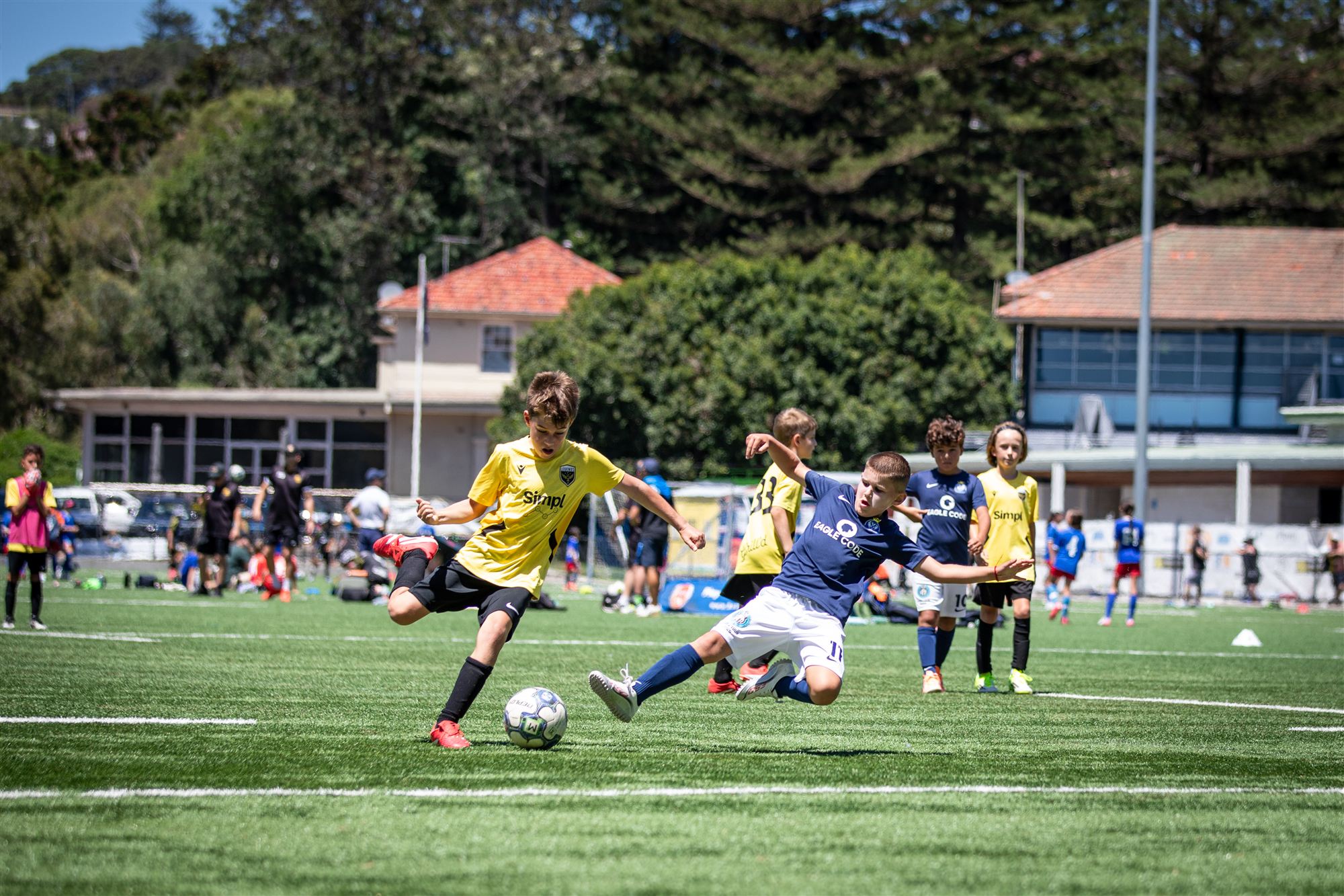 Striker shoots as a defender dives in to block
