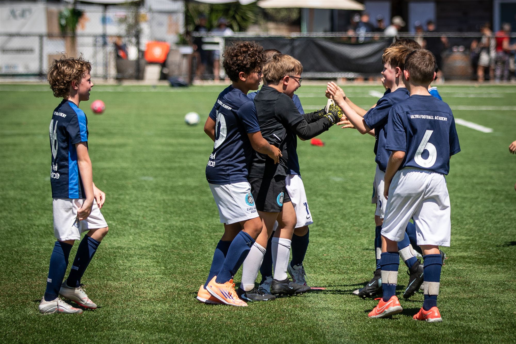 Team huddled together, celebrating as a group